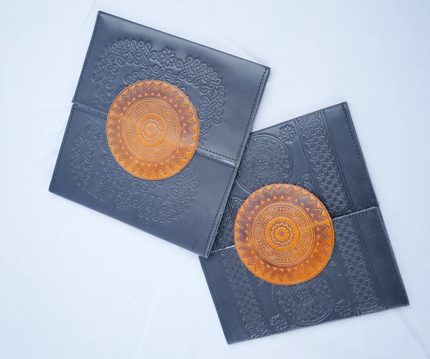 Black leather folios with an embossed leather medallion, made for a client